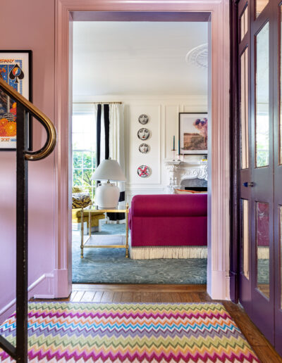 A pink door way leading to the living room.