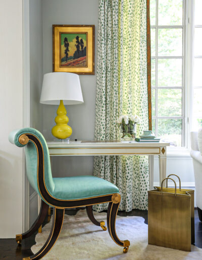 A chair and table in front of a window.